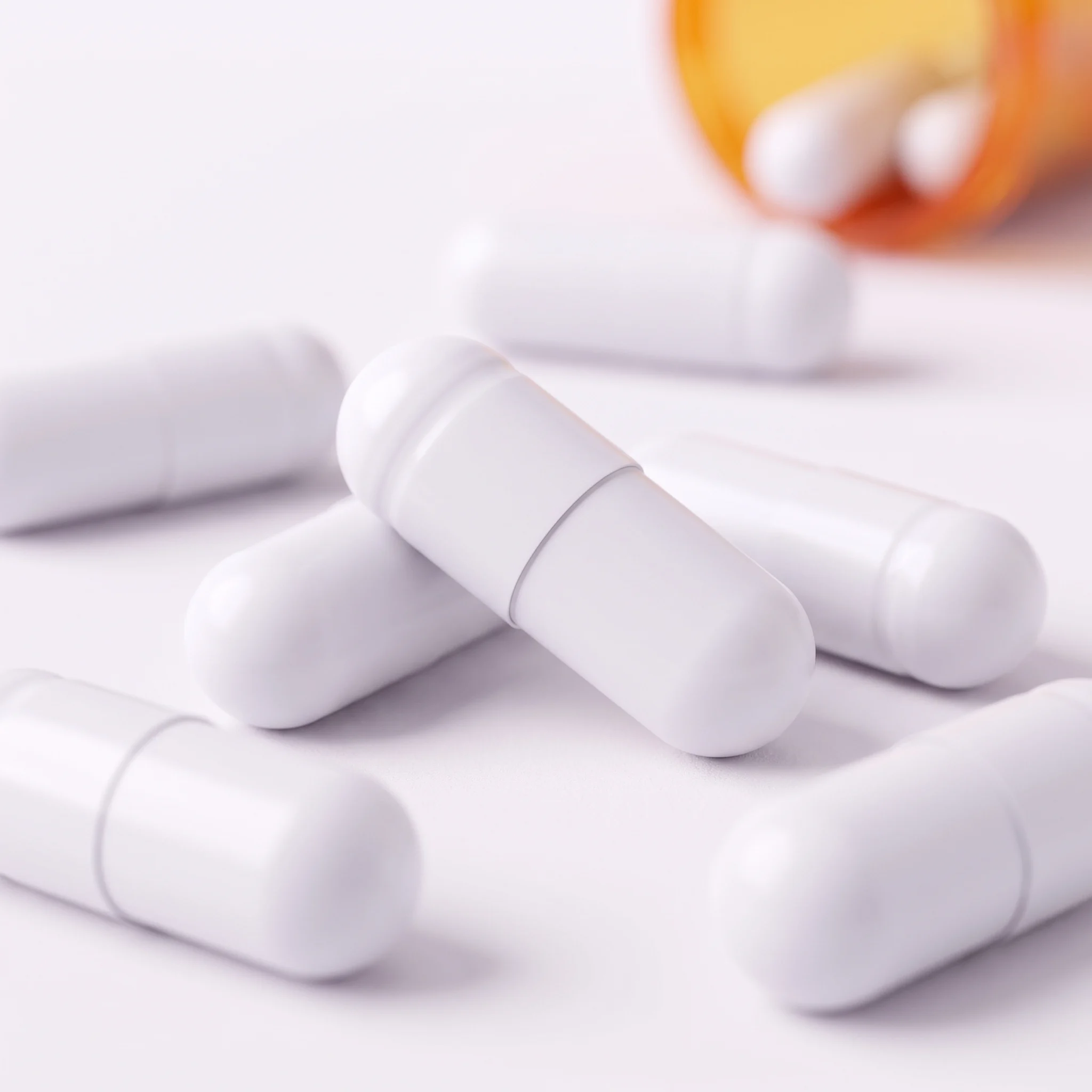 Unlabeled white capsules photographed close up